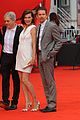 milla jovovich cradles baby bump at premiere 03